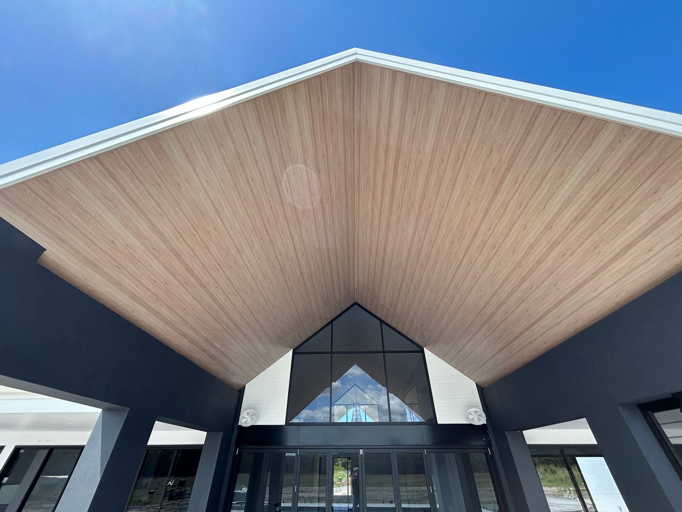 Timber-look aluminium cladding lining a pitched gable soffit