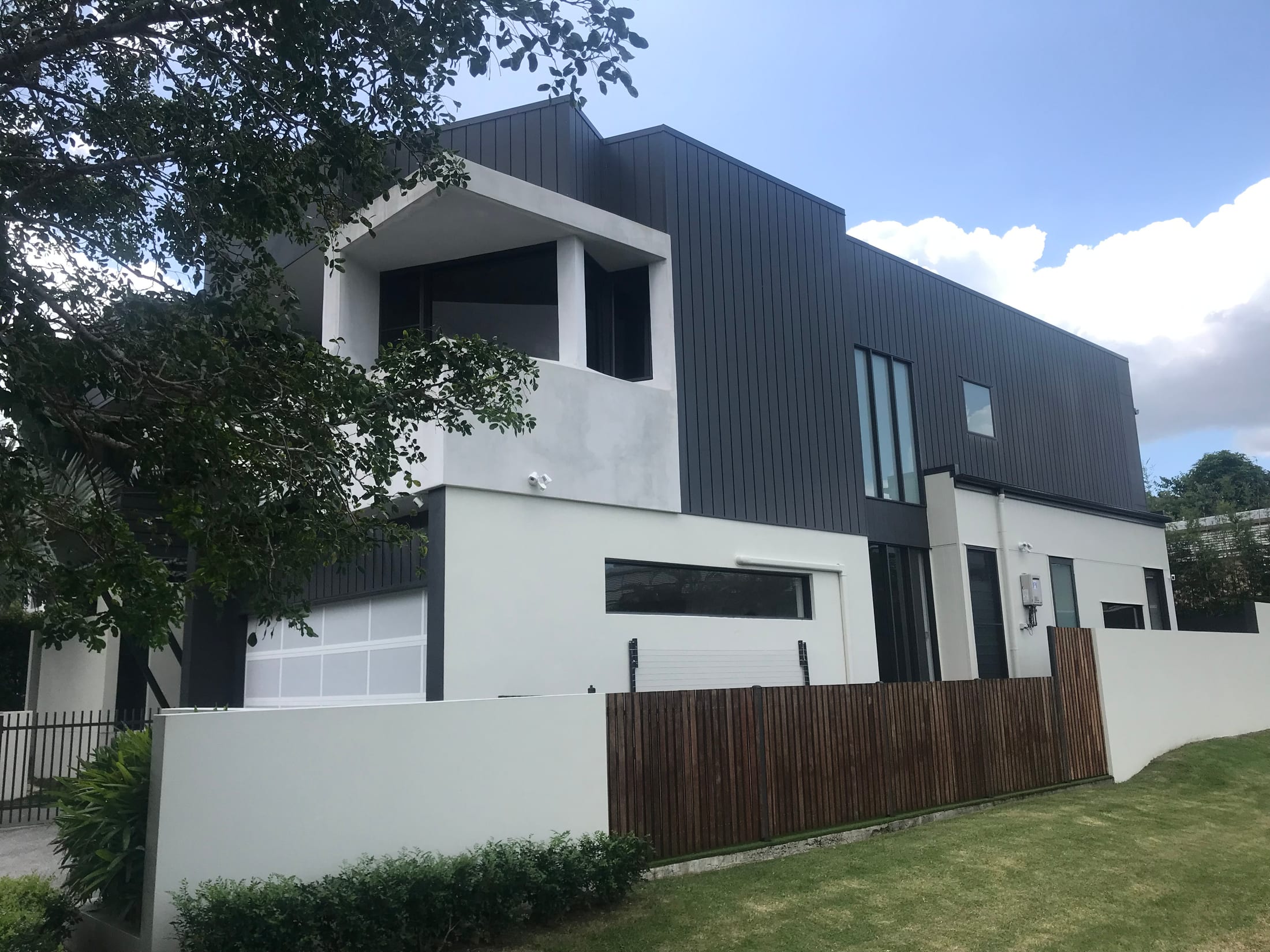 Charcoal vertical-seam aluminium cladding on a contemporary two-storey home