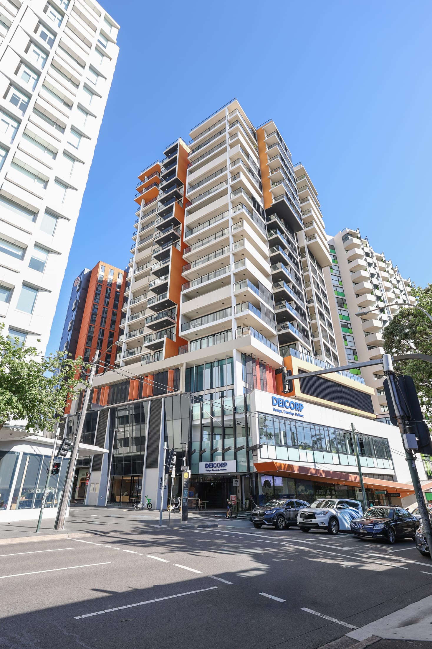 Redfern commercial building with warm timber-look aluminium battens across the upper facade